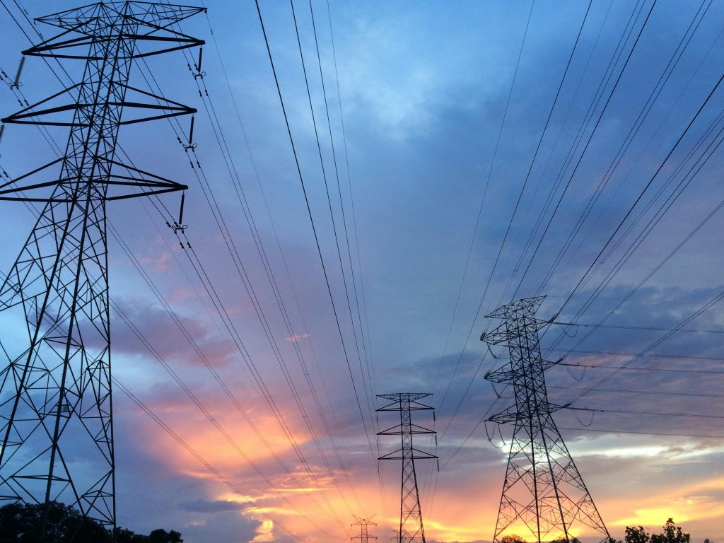 Electric transmission towers against a gray sky